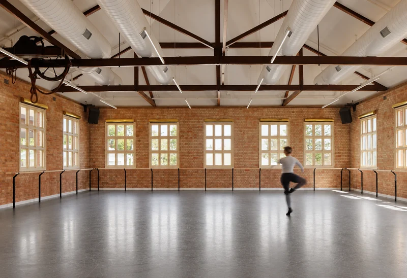 A dancer practising in a sunlit ballet studio